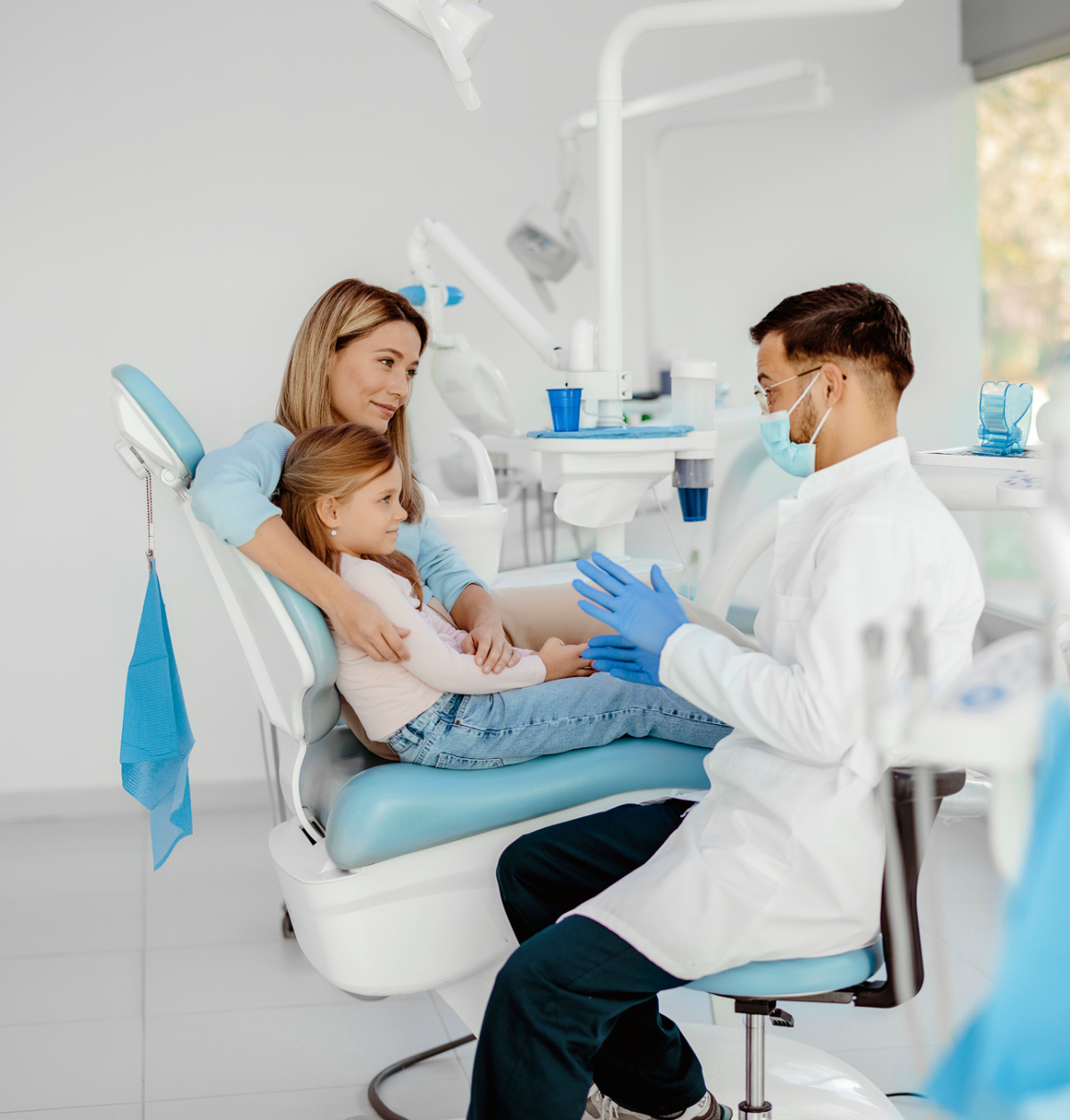 Dentist talking to child and mother