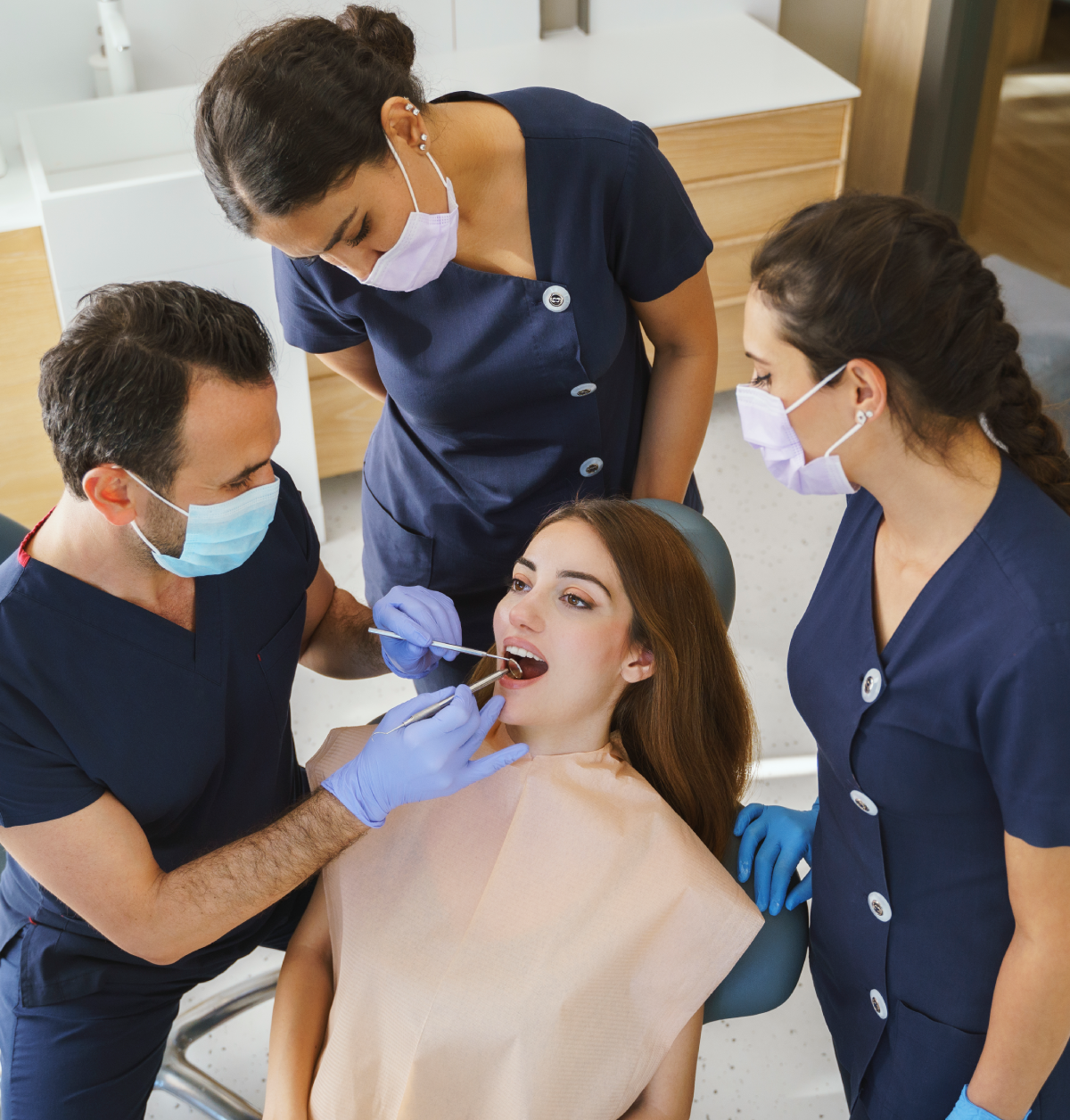 Patient receiving oral examination at dental clinic