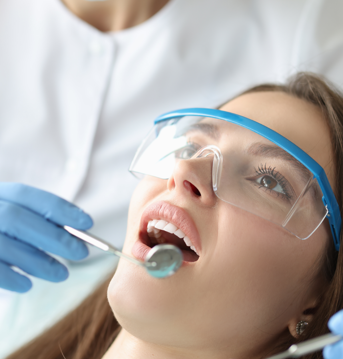 Woman at dentist with safety glasses