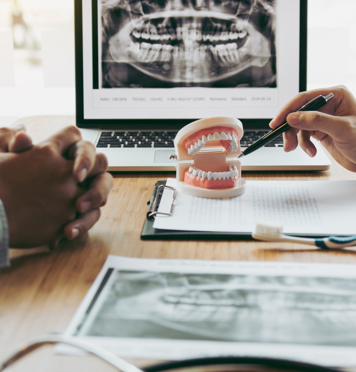 Dentist explaining teeth with model